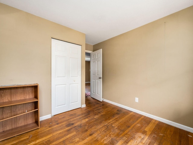 5030 Holbrook Dr, Columbus, OH 43232 - unfurnished bedroom with baseboards, wood finished floors, and a closet