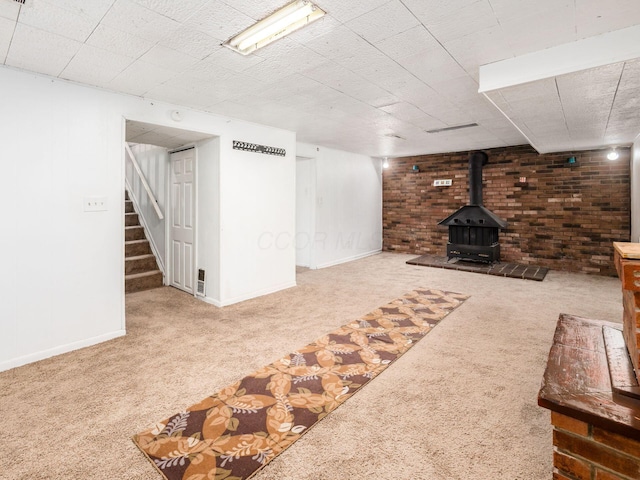 5030 Holbrook Dr, Columbus, OH 43232 - finished basement featuring carpet flooring, baseboards, stairs, and a wood stove