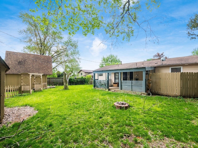 5030 Holbrook Dr, Columbus, OH 43232 - view of yard featuring a fire pit, an outdoor structure, and a shed