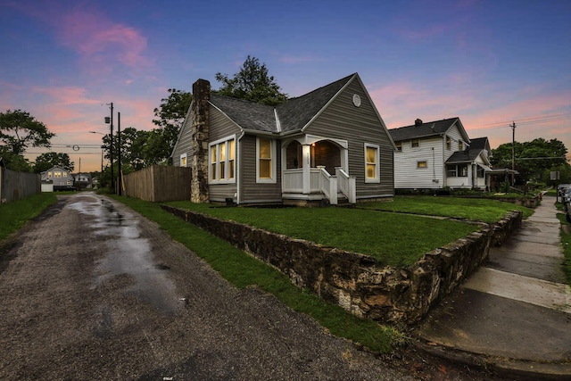 155 N Harris Ave, Columbus, OH 43204 - view of front facade featuring asphalt driveway, a chimney, and a shingled roof