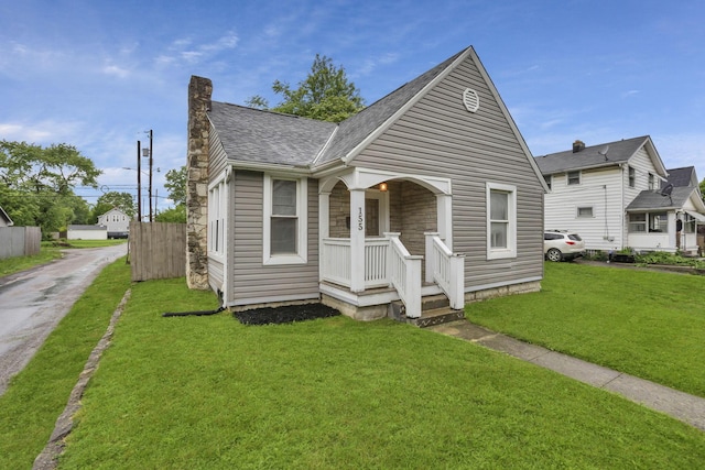 155 N Harris Ave, Columbus, OH 43204 - bungalow-style house featuring a chimney, a front lawn, and a shingled roof