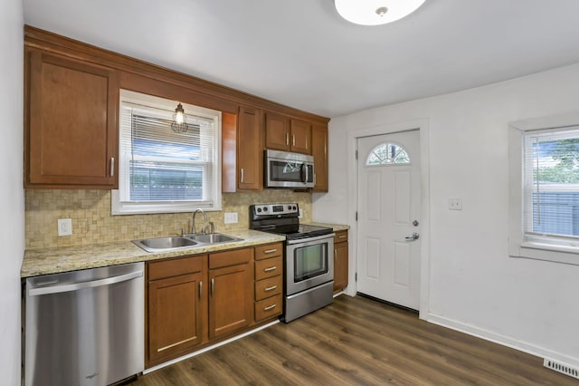 155 N Harris Ave, Columbus, OH 43204 - kitchen with appliances with stainless steel finishes, a sink, decorative backsplash, dark wood finished floors, and baseboards