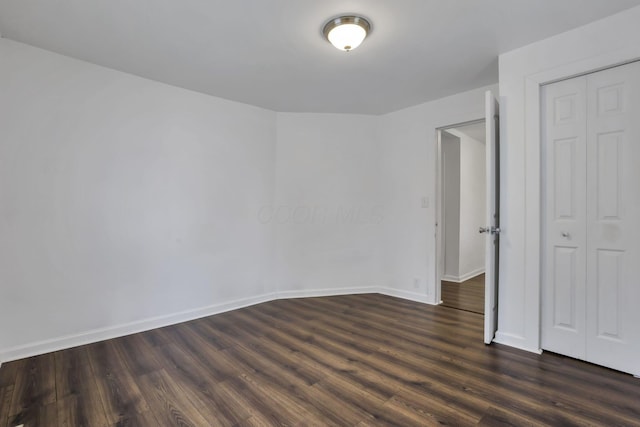 155 N Harris Ave, Columbus, OH 43204 - unfurnished bedroom featuring dark wood-type flooring, baseboards, and a closet