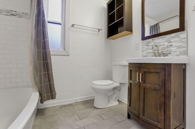 155 N Harris Ave, Columbus, OH 43204 - bathroom with baseboards, toilet, vanity, and tasteful backsplash