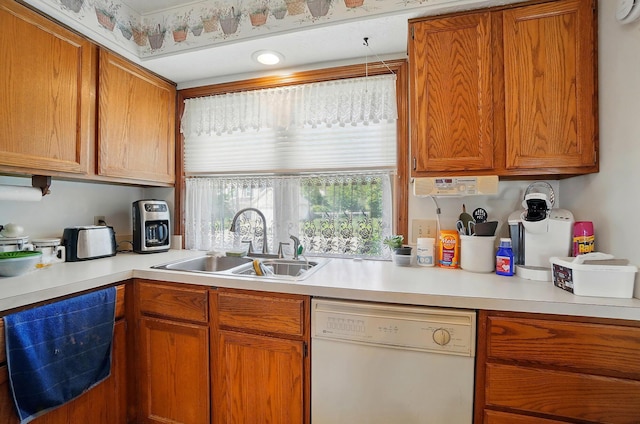 371 Federal Cir, Delaware, OH 43015 - kitchen featuring white dishwasher, dishwashing machine, a sink, light countertops, and brown cabinetry