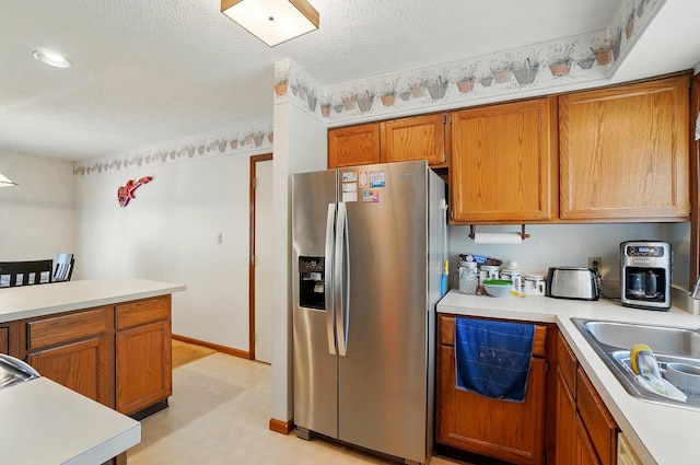 371 Federal Cir, Delaware, OH 43015 - kitchen with stainless steel fridge, light countertops, brown cabinets, a sink, and light floors