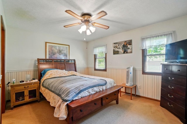 371 Federal Cir, Delaware, OH 43015 - bedroom with a wainscoted wall, light carpet, a textured ceiling, and a ceiling fan
