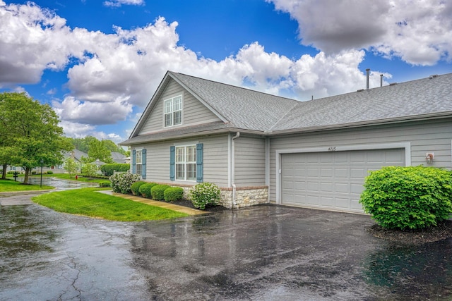 4115 Aumbrey Ct, New Albany, OH 43054 - view of front of house featuring asphalt driveway, an attached garage, roof with shingles, and stone siding