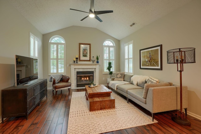 4115 Aumbrey Ct, New Albany, OH 43054 - living room with a fireplace with flush hearth, dark wood finished floors, ceiling fan, lofted ceiling, and a textured ceiling