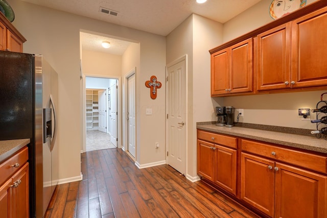 4115 Aumbrey Ct, New Albany, OH 43054 - kitchen featuring stainless steel fridge, dark wood finished floors, brown cabinetry, and baseboards