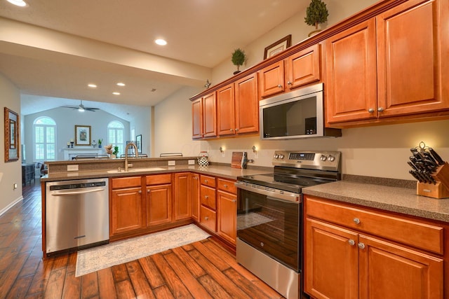 4115 Aumbrey Ct, New Albany, OH 43054 - kitchen with appliances with stainless steel finishes, a sink, a peninsula, dark wood finished floors, and brown cabinetry