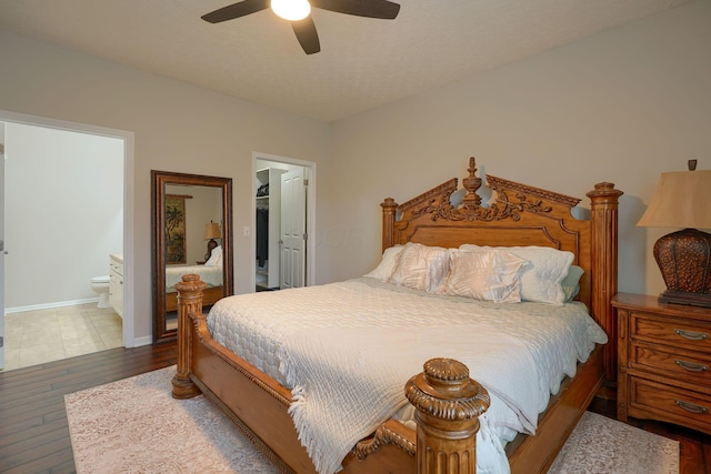 4115 Aumbrey Ct, New Albany, OH 43054 - bedroom with wood finished floors, a walk in closet, a closet, ensuite bathroom, and baseboards