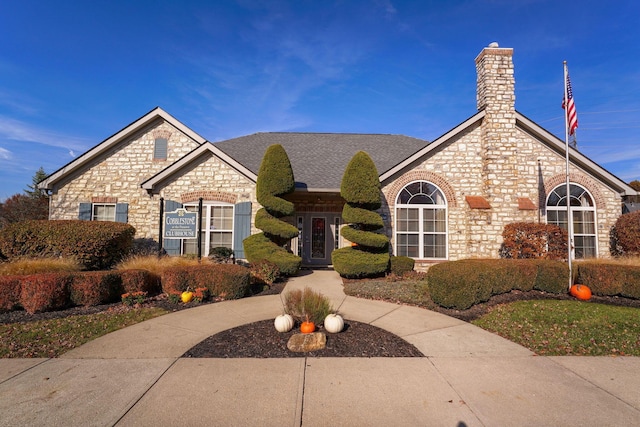 4115 Aumbrey Ct, New Albany, OH 43054 - view of front of property with a chimney, stone siding, a shingled roof, and french doors