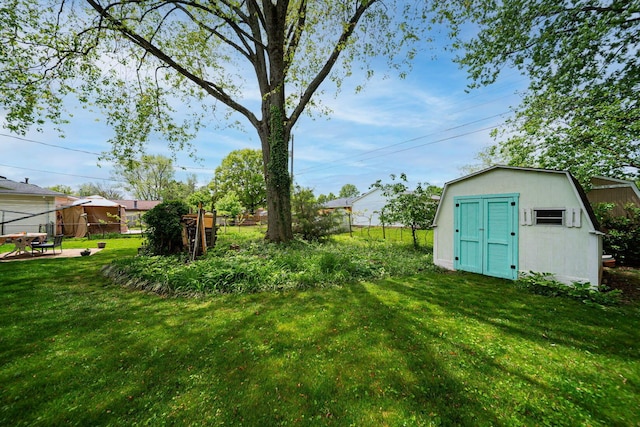 6241 Faircrest Rd, Columbus, OH 43229 - view of yard with a storage unit and an outbuilding