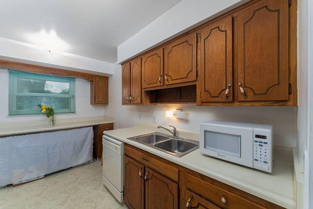 6241 Faircrest Rd, Columbus, OH 43229 - kitchen with white appliances, a sink, brown cabinetry, and light countertops
