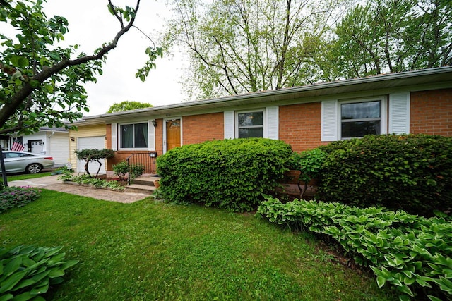 6241 Faircrest Rd, Columbus, OH 43229 - ranch-style house featuring an attached garage, brick siding, and a front lawn