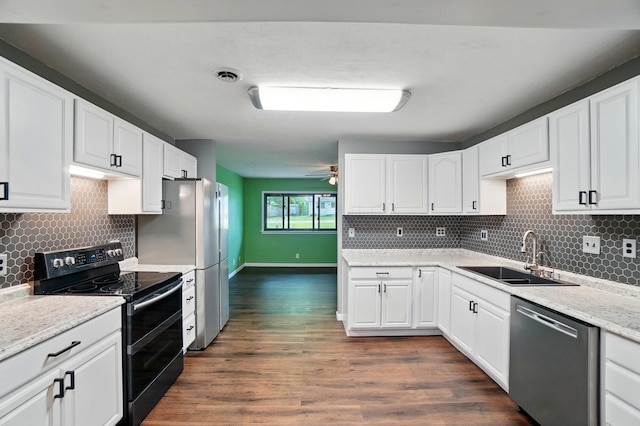 820 N Walnut St, Baltimore, OH 43105 - kitchen featuring appliances with stainless steel finishes, a sink, backsplash, and dark wood-style flooring