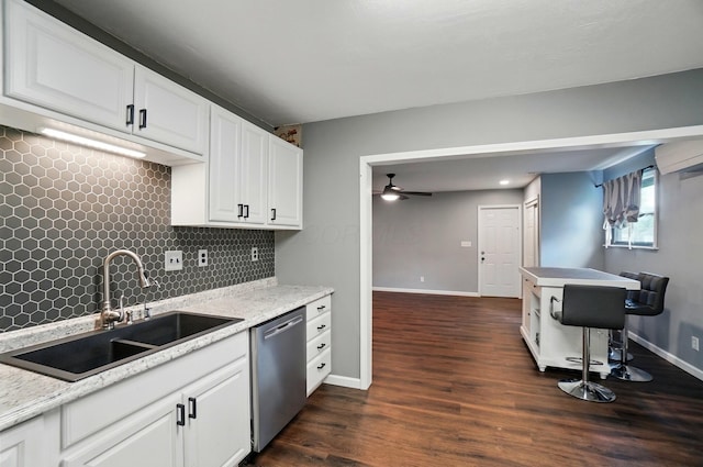 820 N Walnut St, Baltimore, OH 43105 - kitchen with stainless steel dishwasher, a sink, ceiling fan, decorative backsplash, and dark wood finished floors