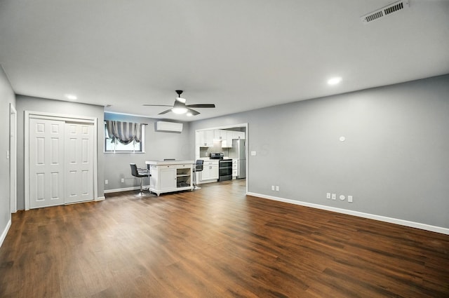820 N Walnut St, Baltimore, OH 43105 - unfurnished living room with a wall mounted AC, baseboards, dark wood-style floors, and recessed lighting