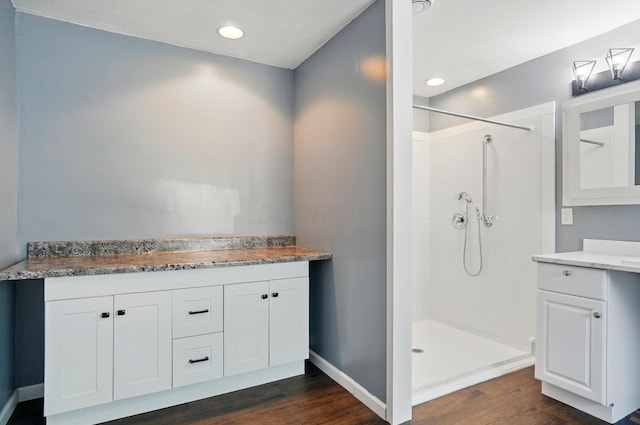 820 N Walnut St, Baltimore, OH 43105 - full bathroom featuring wood finished floors, a walk in shower, vanity, baseboards, and recessed lighting