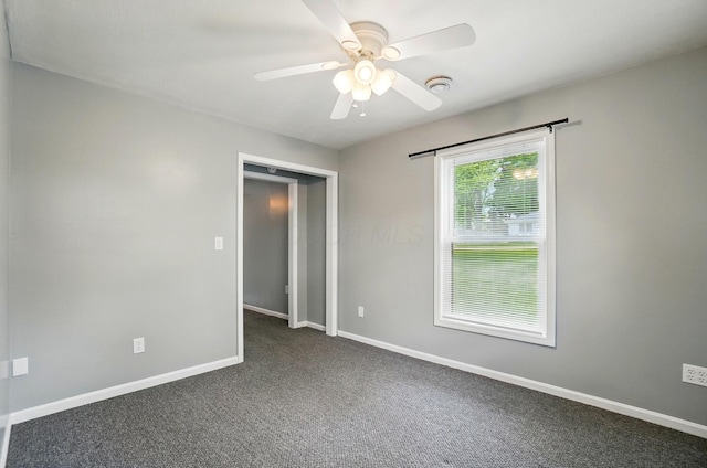 820 N Walnut St, Baltimore, OH 43105 - spare room with a ceiling fan, dark carpet, and baseboards