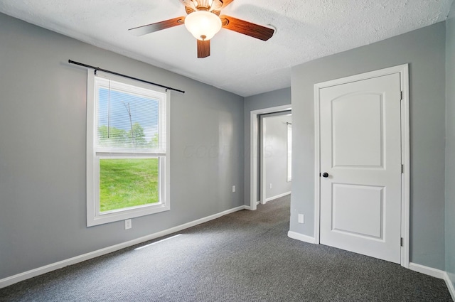 820 N Walnut St, Baltimore, OH 43105 - unfurnished bedroom with dark colored carpet, baseboards, ceiling fan, and a textured ceiling