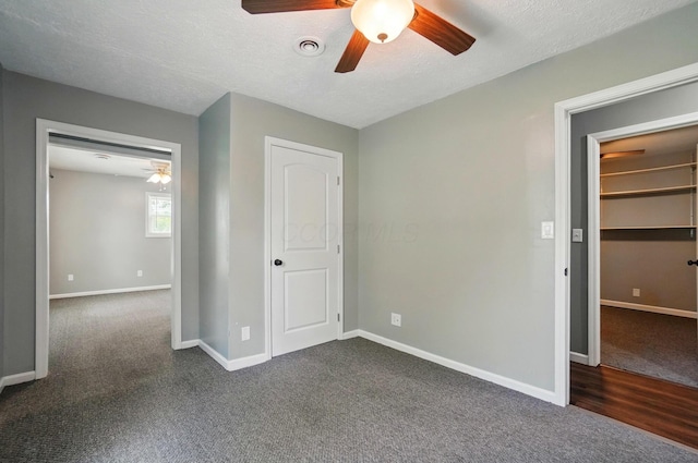 820 N Walnut St, Baltimore, OH 43105 - unfurnished bedroom with dark colored carpet, baseboards, a ceiling fan, and a textured ceiling