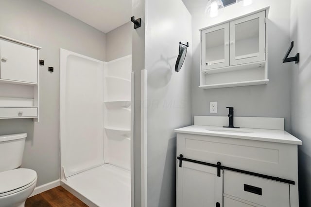 820 N Walnut St, Baltimore, OH 43105 - bathroom featuring a stall shower, wood finished floors, toilet, vanity, and baseboards