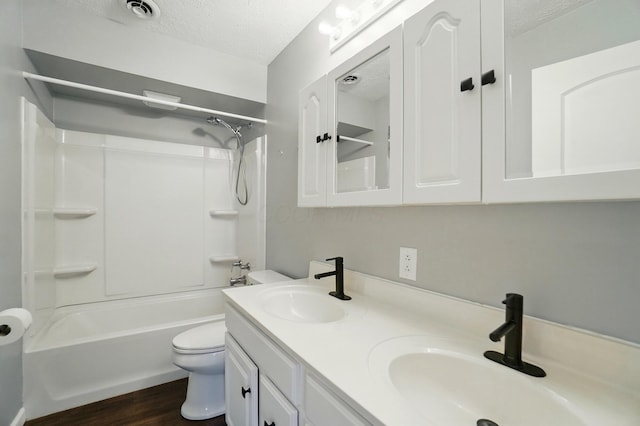820 N Walnut St, Baltimore, OH 43105 - full bathroom with a textured ceiling, toilet, double vanity, wood finished floors, and shower / tub combination
