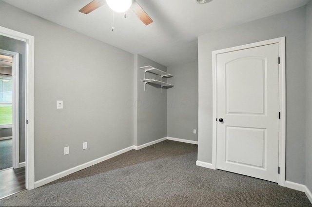 820 N Walnut St, Baltimore, OH 43105 - unfurnished bedroom featuring dark carpet, baseboards, and ceiling fan