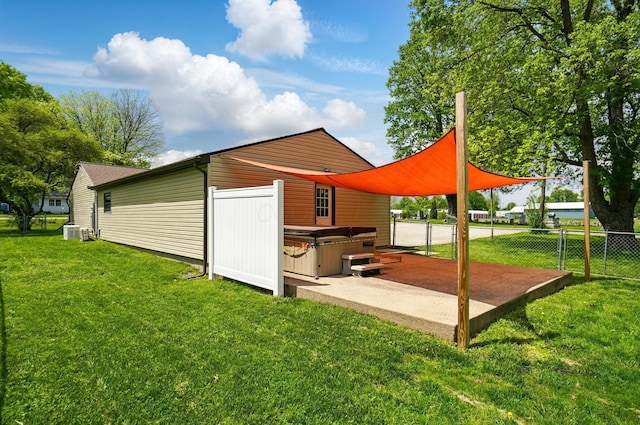 820 N Walnut St, Baltimore, OH 43105 - back of property with a hot tub, a patio area, and central AC