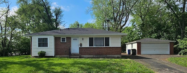 bungalow-style home featuring entry steps, brick siding, a detached garage, an outdoor structure, and a front lawn