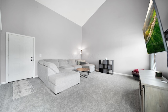 carpeted living room featuring high vaulted ceiling and baseboards