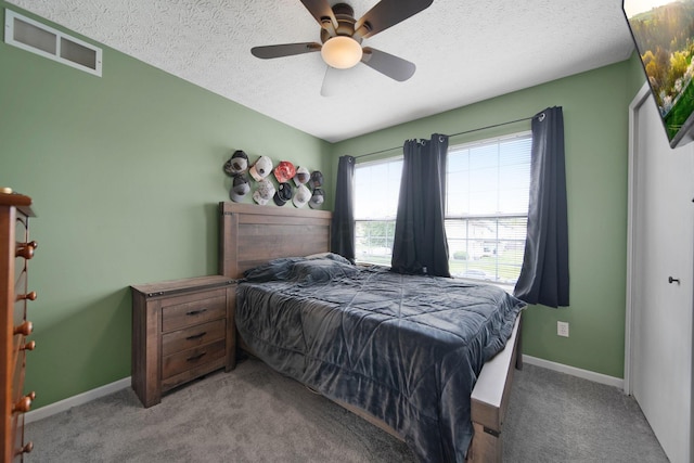 bedroom featuring carpet flooring, a textured ceiling, baseboards, and ceiling fan
