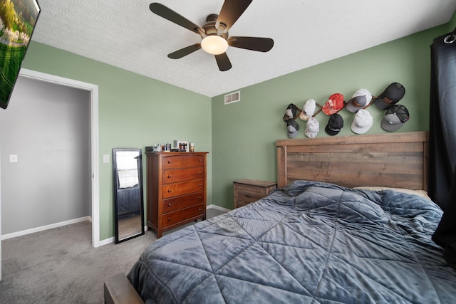 carpeted bedroom with baseboards, a ceiling fan, and a textured ceiling