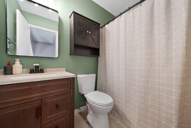 bathroom featuring toilet, vanity, tile patterned floors, and a textured ceiling