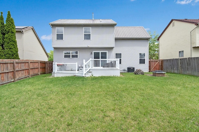 rear view of property featuring a wooden deck, metal roof, and central AC unit