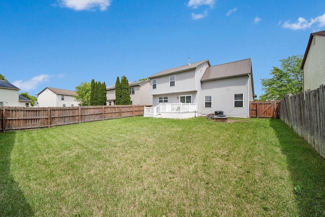 rear view of property with metal roof and a wooden deck