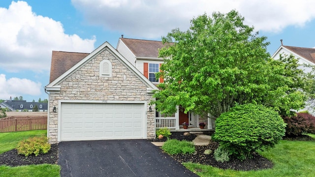1980 Maxwell Ave, Lewis Center, OH 43035 - view of front facade featuring stone siding, driveway, an attached garage, and a shingled roof