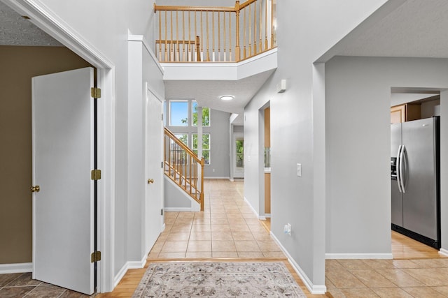 1980 Maxwell Ave, Lewis Center, OH 43035 - entryway with stairs, light tile patterned floors, baseboards, and a towering ceiling