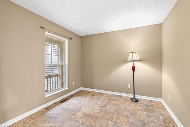 1980 Maxwell Ave, Lewis Center, OH 43035 - empty room with baseboards, a textured ceiling, and stone finish floors