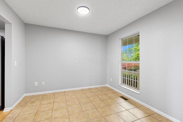 1980 Maxwell Ave, Lewis Center, OH 43035 - spare room with a textured ceiling, light tile patterned flooring, and baseboards