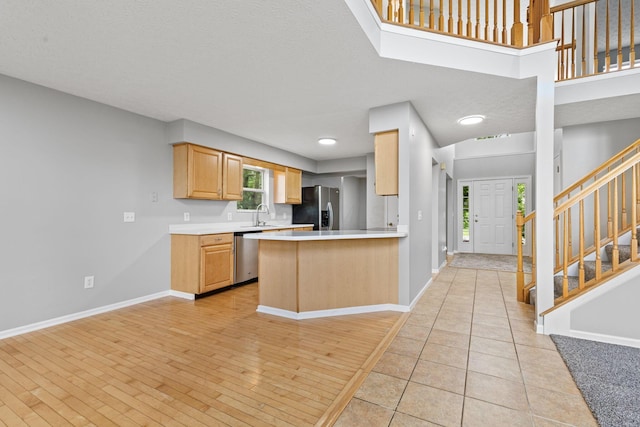 1980 Maxwell Ave, Lewis Center, OH 43035 - kitchen with appliances with stainless steel finishes, a sink, light countertops, baseboards, and a peninsula