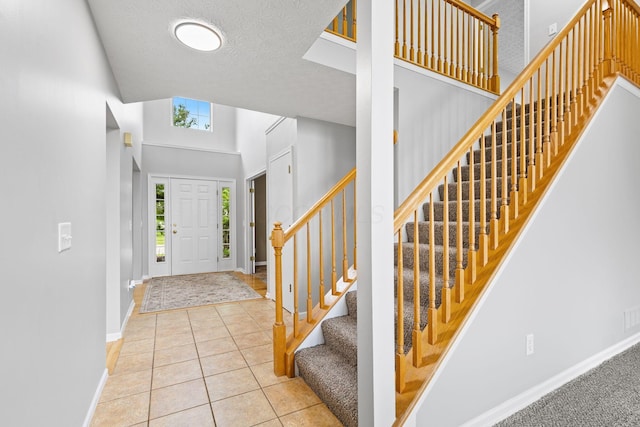 1980 Maxwell Ave, Lewis Center, OH 43035 - tiled foyer featuring stairs, baseboards, and a textured ceiling