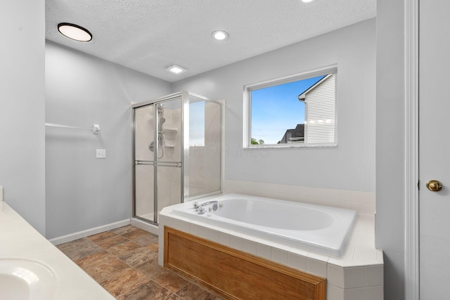 1980 Maxwell Ave, Lewis Center, OH 43035 - bathroom with a textured ceiling, a stall shower, a garden tub, stone finish flooring, and a sink