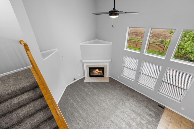 1980 Maxwell Ave, Lewis Center, OH 43035 - unfurnished living room featuring plenty of natural light, carpet flooring, ceiling fan, and a tiled fireplace