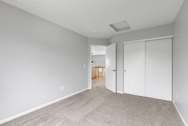 1980 Maxwell Ave, Lewis Center, OH 43035 - unfurnished bedroom with attic access, carpet floors, a textured ceiling, baseboards, and a closet