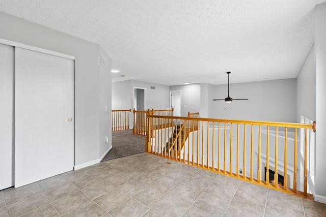 1980 Maxwell Ave, Lewis Center, OH 43035 - hallway with an upstairs landing, tile patterned floors, a textured ceiling, and baseboards