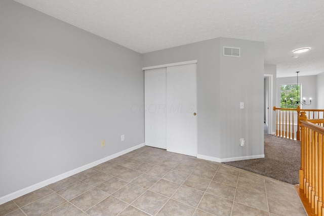 1980 Maxwell Ave, Lewis Center, OH 43035 - unfurnished room featuring a chandelier, baseboards, a textured ceiling, and tile patterned floors