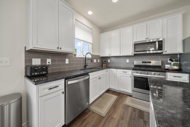 136 Bigelow Dr, Johnstown, OH 43031 - kitchen with appliances with stainless steel finishes, a sink, dark wood finished floors, white cabinetry, and dark stone counters